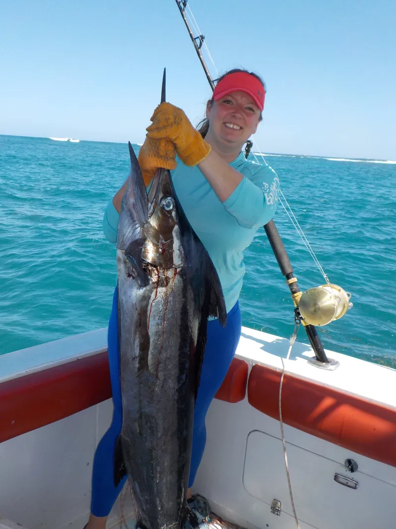 Gone Fishing Punta Cana fisherman holding up Marlin from fishing tour
